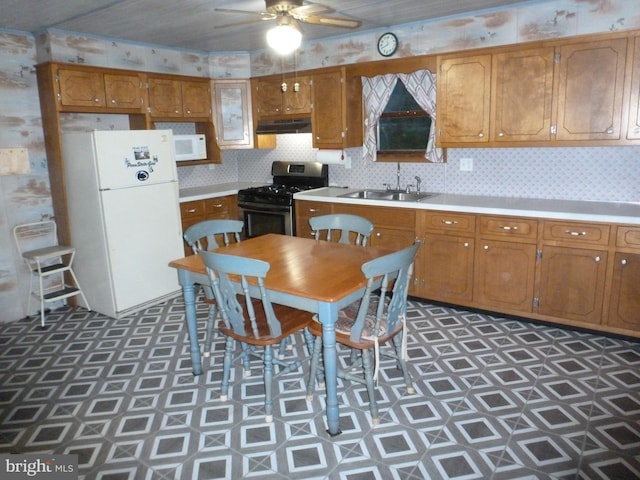 kitchen with ceiling fan, white appliances, sink, and backsplash