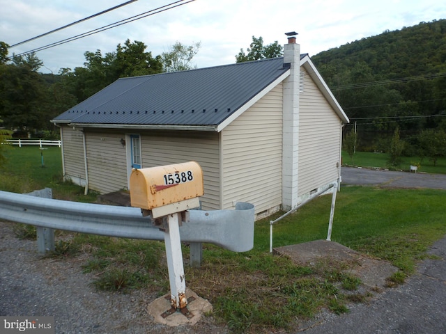 view of side of home with a lawn