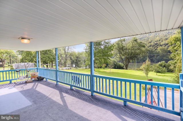 wooden deck featuring a lawn