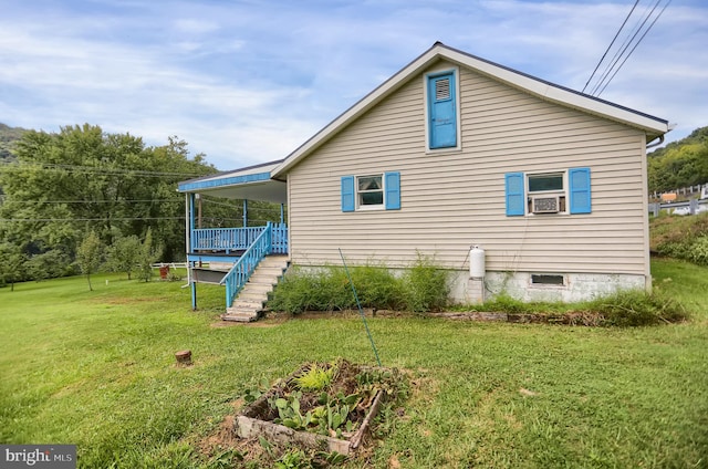 view of home's exterior featuring covered porch and a lawn