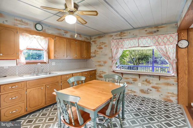 kitchen with wood ceiling, ceiling fan, sink, and tasteful backsplash