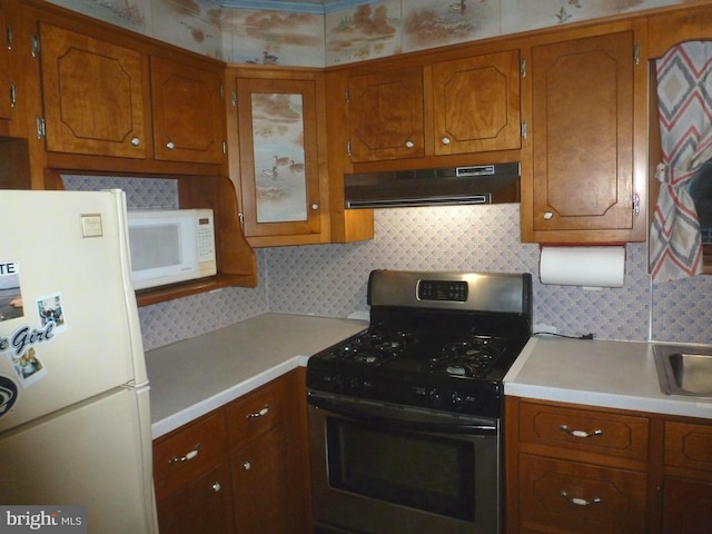 kitchen with tasteful backsplash and white appliances