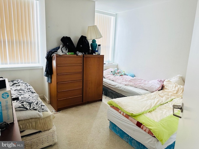 bedroom featuring light colored carpet