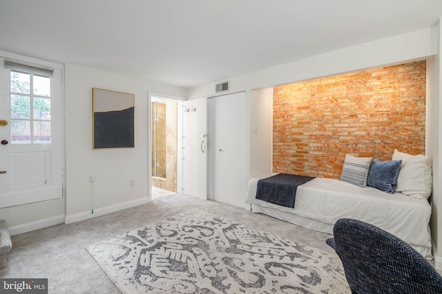 interior space with brick wall and carpet flooring