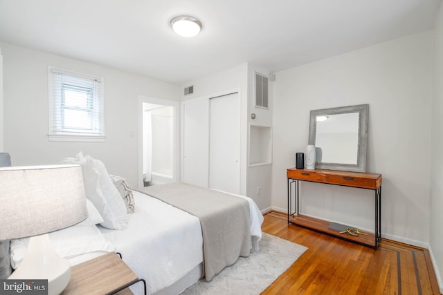 bedroom featuring light hardwood / wood-style floors and a closet