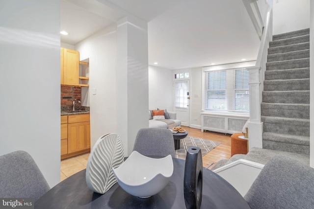 living room with sink and light hardwood / wood-style flooring