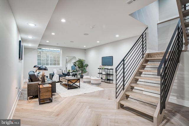 living area featuring stairs, baseboards, and recessed lighting