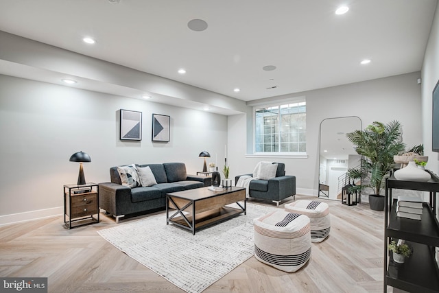 living area featuring recessed lighting and baseboards