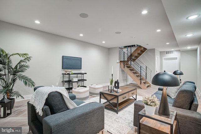 living room featuring recessed lighting, visible vents, stairway, and baseboards