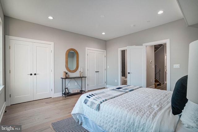 bedroom with multiple closets, recessed lighting, baseboards, and light wood finished floors