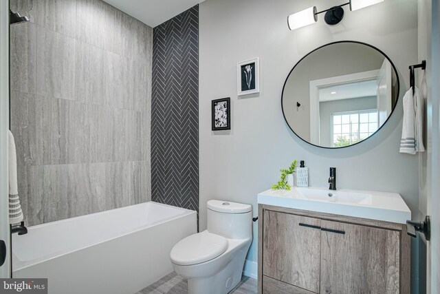 full bathroom with tiled shower / bath combo, toilet, and vanity