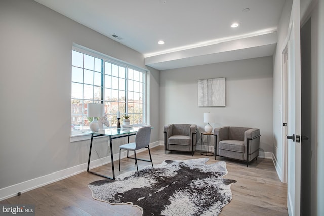 office space featuring baseboards, recessed lighting, visible vents, and light wood-style floors