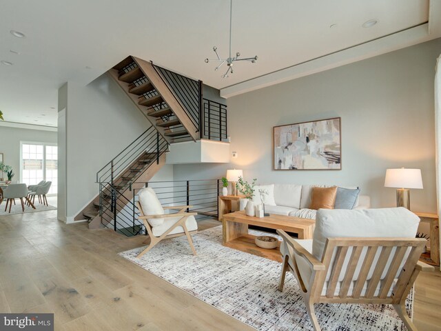 living room featuring light hardwood / wood-style floors and a chandelier