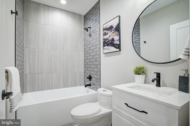 bathroom featuring vanity, toilet, and shower / bathtub combination