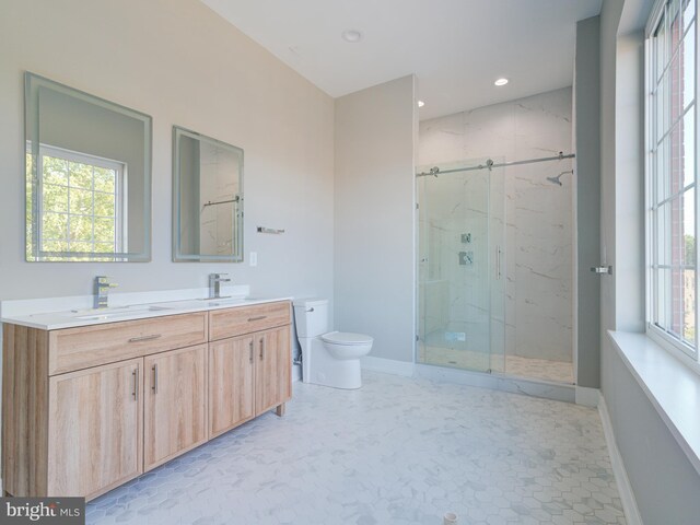 bathroom featuring tile patterned flooring, a shower with door, vanity, and toilet