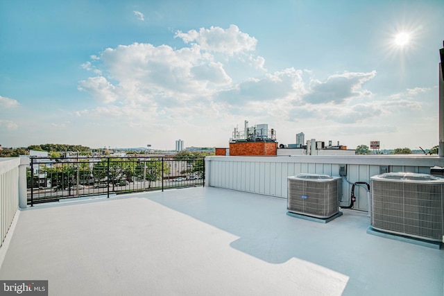 view of patio / terrace with cooling unit, a balcony, and a view of city