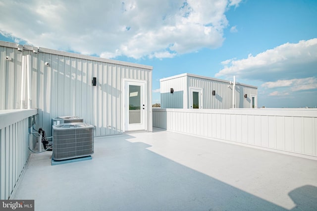 view of patio with central air condition unit and fence