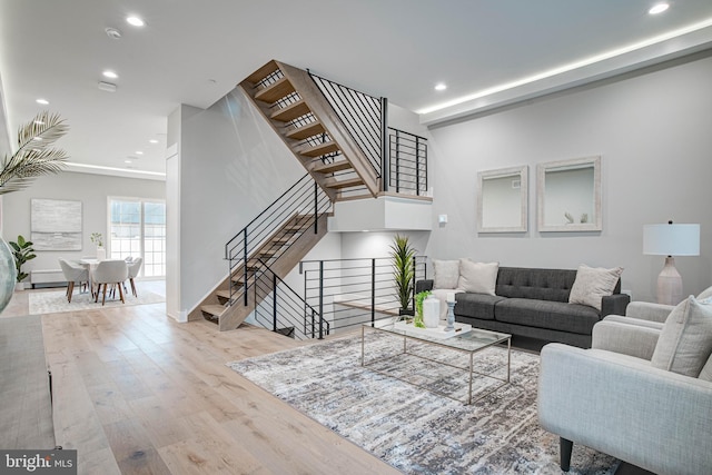 living area featuring light wood-style floors, stairs, and recessed lighting