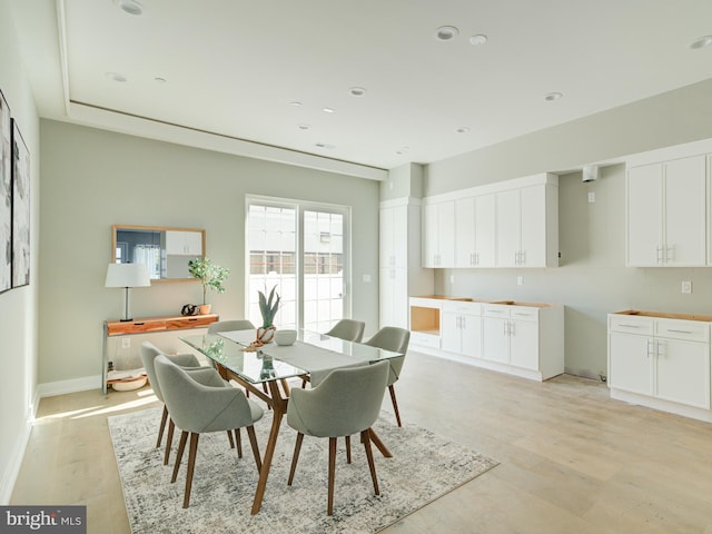 dining room featuring light wood-style floors, baseboards, and recessed lighting