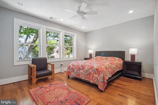 bedroom with ceiling fan and hardwood / wood-style floors