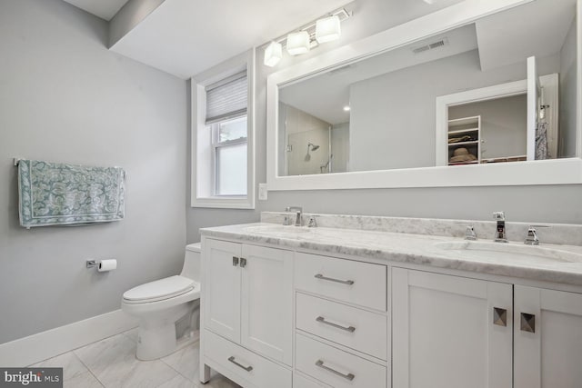 bathroom featuring vanity, toilet, and a shower