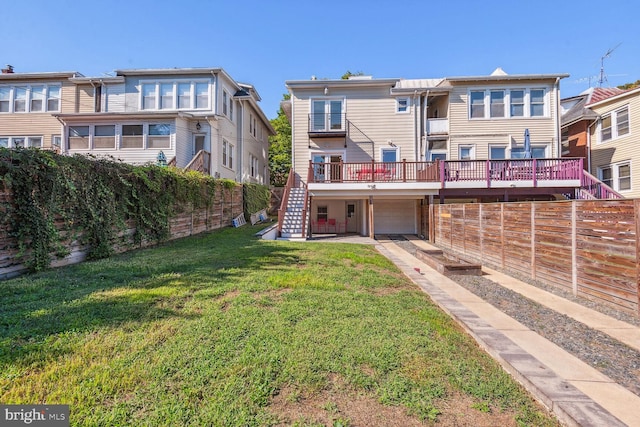 rear view of property with a lawn and a garage