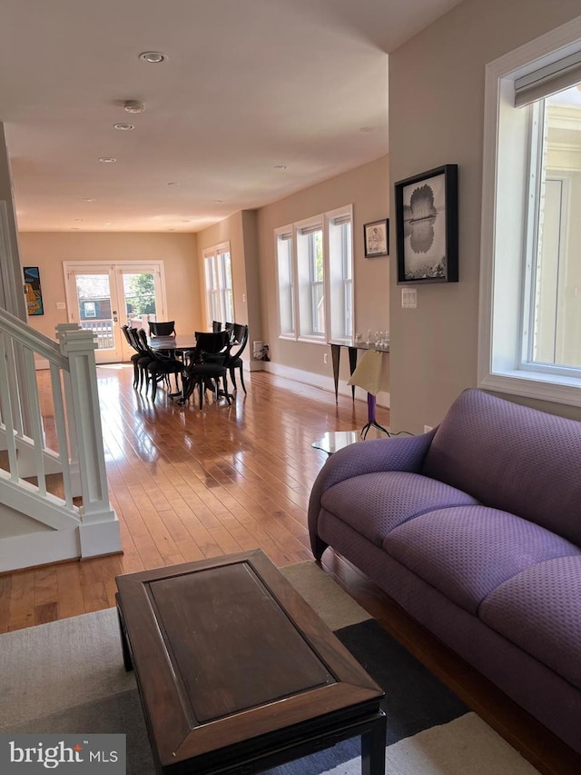 living room featuring light wood-type flooring and a wealth of natural light