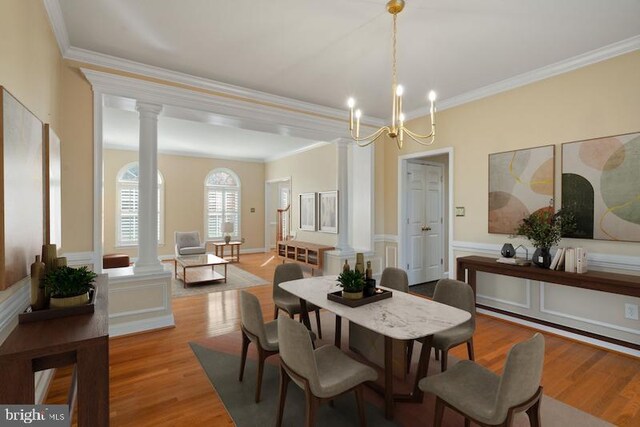 living room with light hardwood / wood-style floors, ornate columns, and ceiling fan