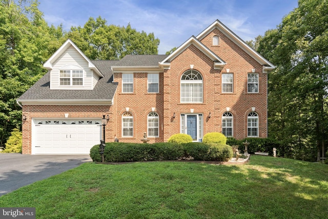 view of front of house with a front yard and a garage