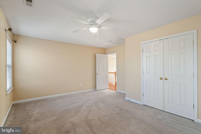 living area featuring carpet flooring, a wealth of natural light, and ceiling fan