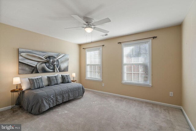 bedroom featuring ceiling fan and light carpet