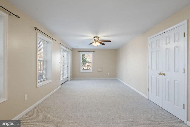 carpeted dining space with ceiling fan