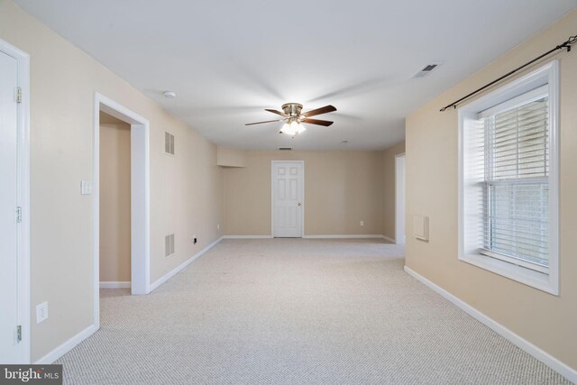 interior space with ceiling fan and light colored carpet