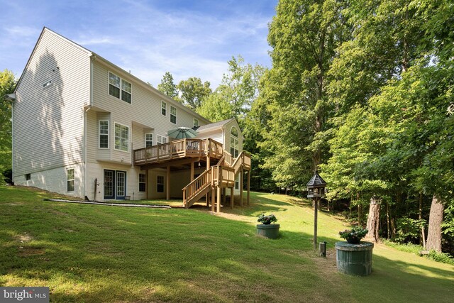 rear view of house with a lawn and a deck