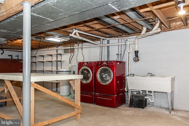 basement featuring washer and clothes dryer and sink