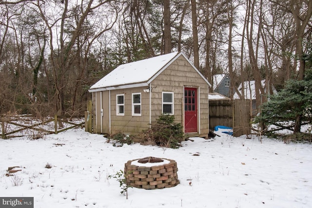 snow covered structure featuring a fire pit