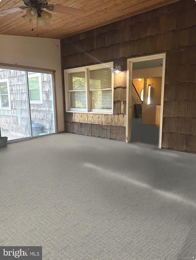 interior space featuring wood ceiling and ceiling fan