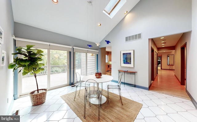 interior space with high vaulted ceiling and a skylight