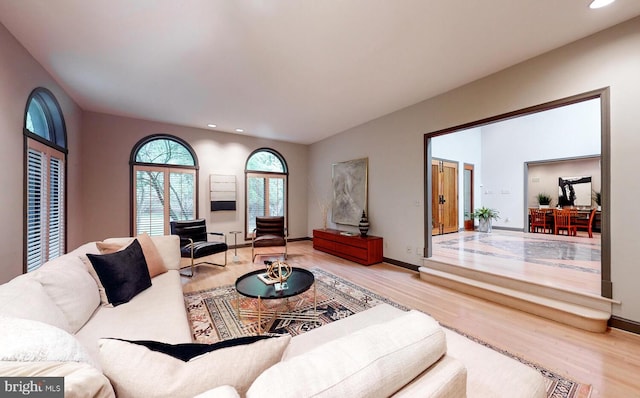 living room with recessed lighting, baseboards, and wood finished floors