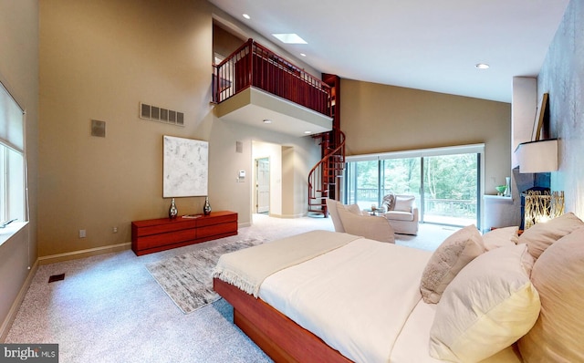 carpeted bedroom featuring access to outside, a fireplace, visible vents, and high vaulted ceiling