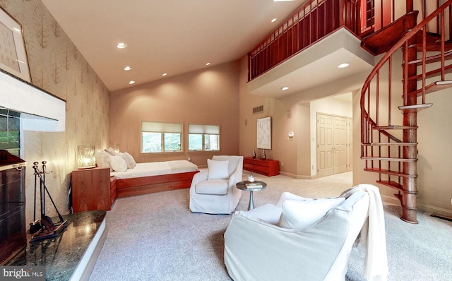 carpeted living room with high vaulted ceiling