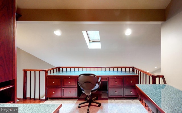 office area featuring vaulted ceiling with skylight