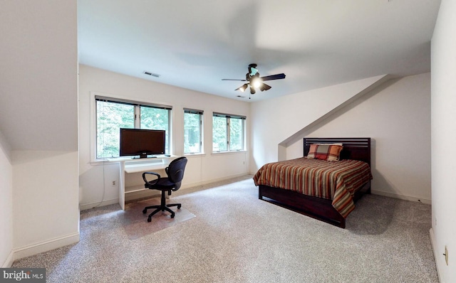 carpeted bedroom featuring visible vents, baseboards, and a ceiling fan