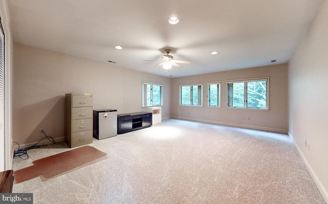 interior space with recessed lighting, light colored carpet, a ceiling fan, and baseboards