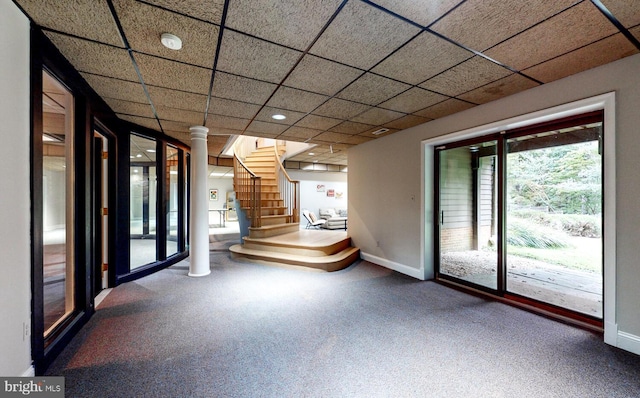 interior space featuring a drop ceiling, stairway, carpet floors, and baseboards