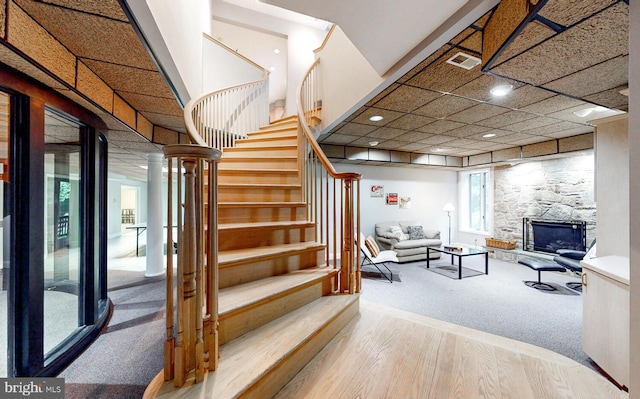 interior space featuring hardwood / wood-style flooring and a stone fireplace