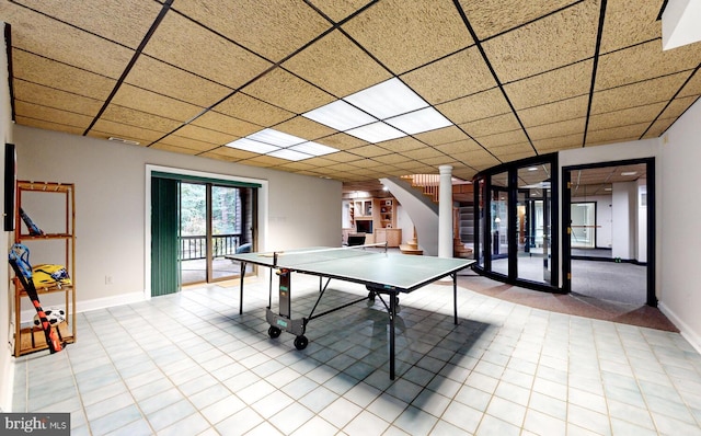 playroom featuring light tile patterned flooring and a paneled ceiling