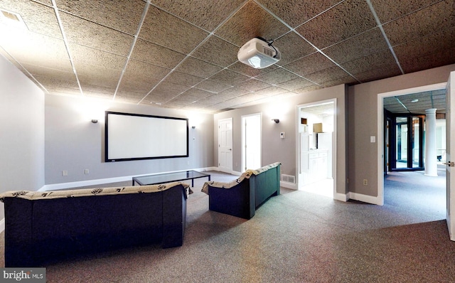 home theater room with a drop ceiling and carpet