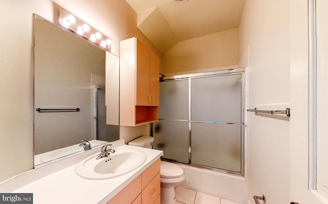 full bathroom with tile patterned flooring, bath / shower combo with glass door, vanity, and toilet