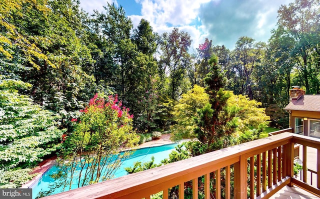 wooden terrace featuring a swimming pool